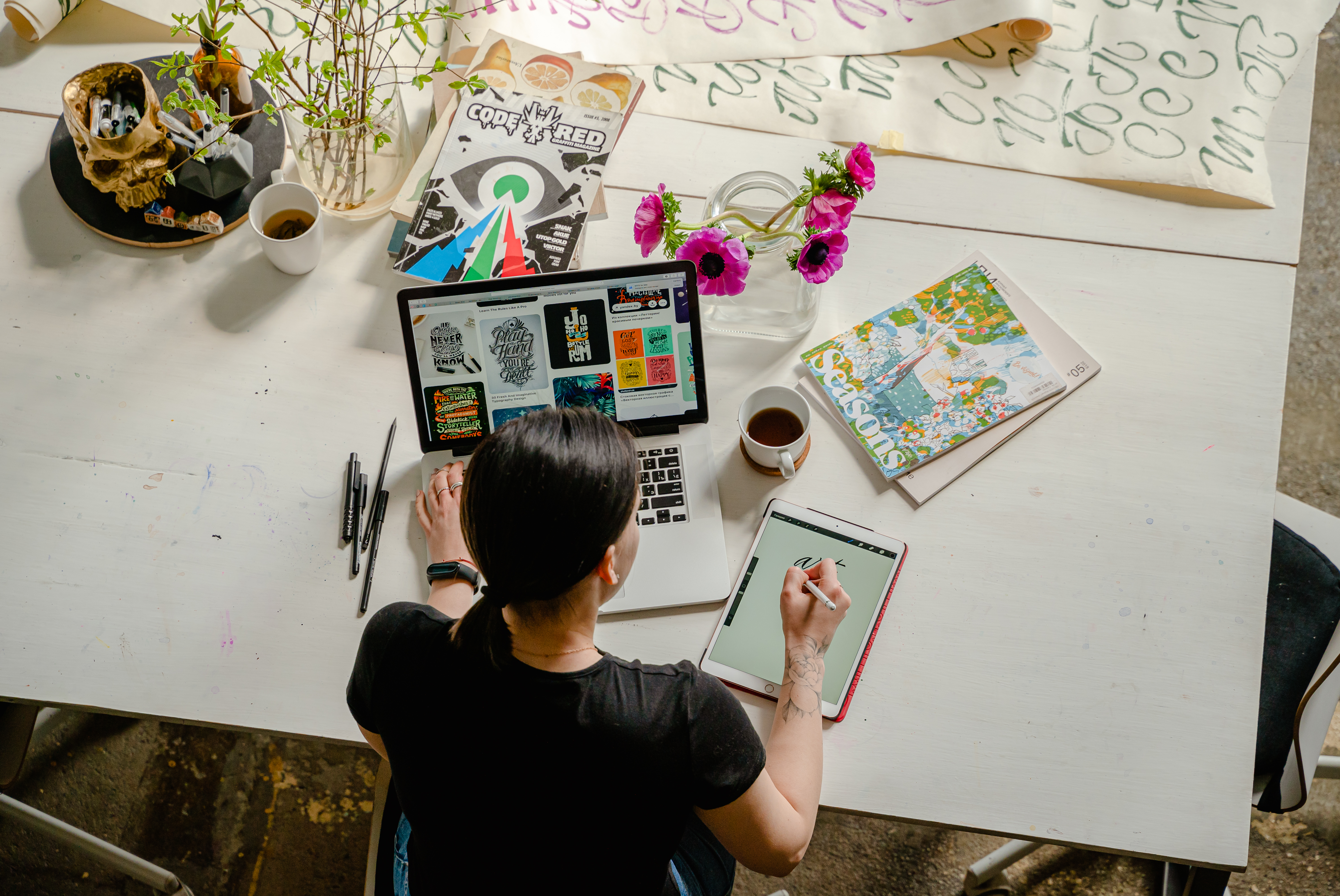 photo of woman writing on tablet computer while using laptop stockpack pexels